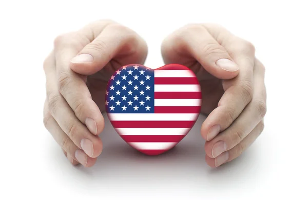 Hands covering U.S. heart on white background — Stok fotoğraf