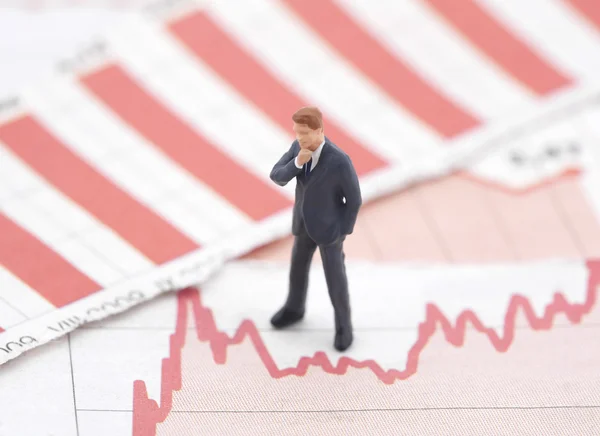 Financial crisis. Figure of businessman on financial charts — Stock Photo, Image