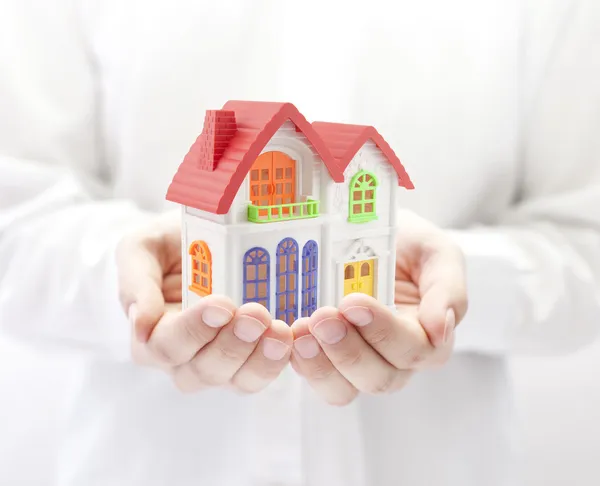 Colorful house in hands — Stock Photo, Image