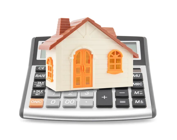 Small orange toy house on calculator