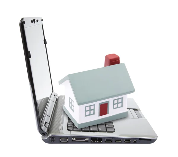 Toy house on laptop isolated on white — Stock Photo, Image