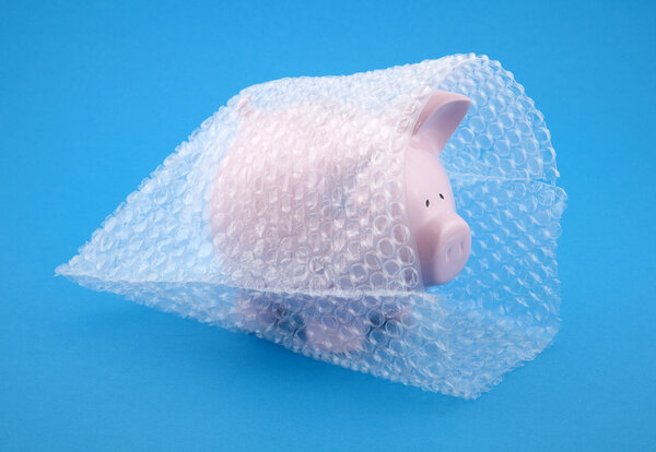 Piggy bank in bubble wrap, protect your money