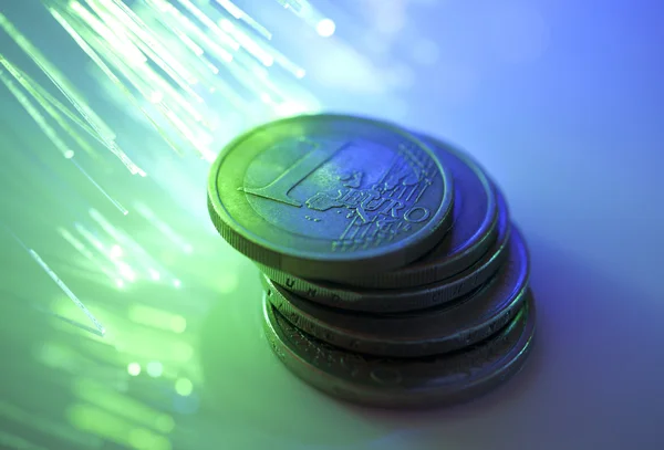 Euro coins on fiber optics background — Stock Photo, Image