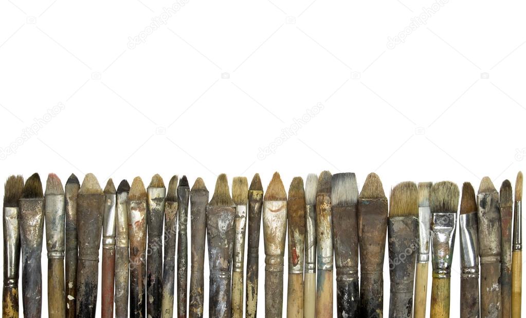 Old paintbrushes in a row with clipping path