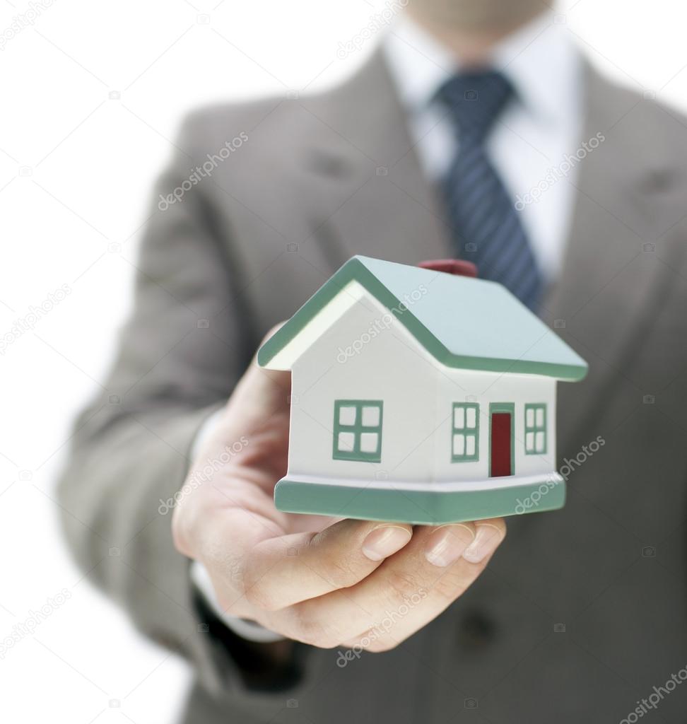 Real estate agent holding a toy house