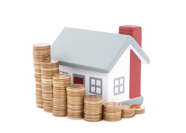 House with stack of coins. Clipping path included. — Stock Photo, Image