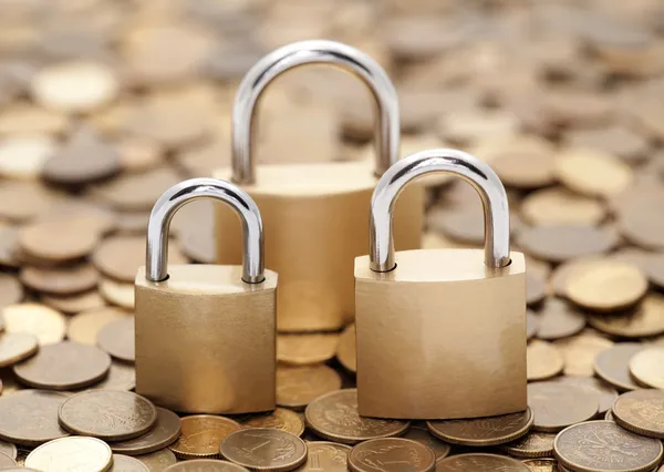 Financial security. Golden coins and padlocks.