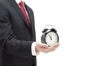 işadamı ile bir el üzerinde beyaz izole bir çalar saat.