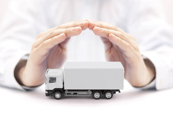 White cargo delivery truck protected by hands