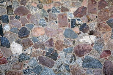 Stone wall with different colors and size of rocks