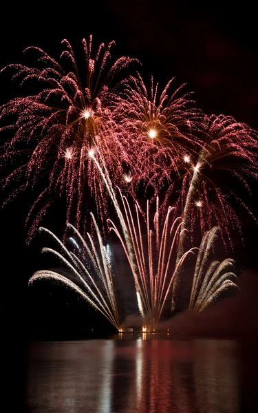 Colorful fireworks show above the lake — Stock Photo, Image