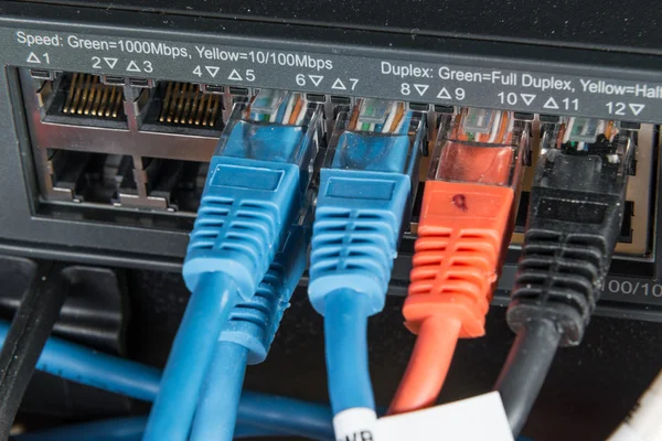 Network hub and patch cables — Stock Photo, Image