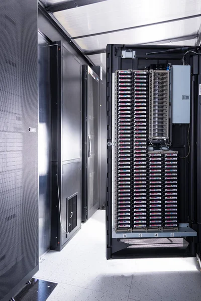 an opened door of data center cabinet filled with data storage h