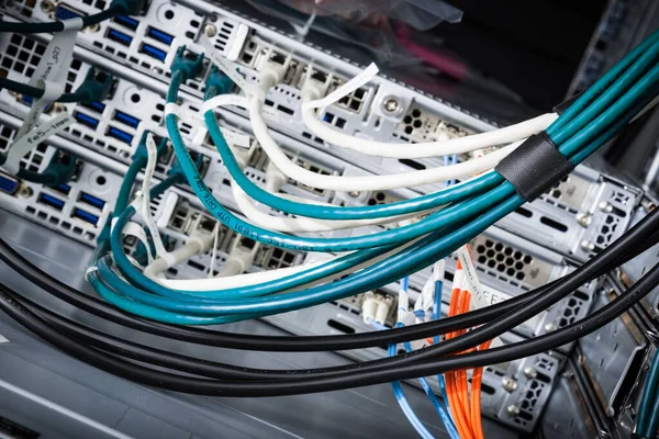 fiber optic cables connected to optic ports, network cables connected to ethernet ports