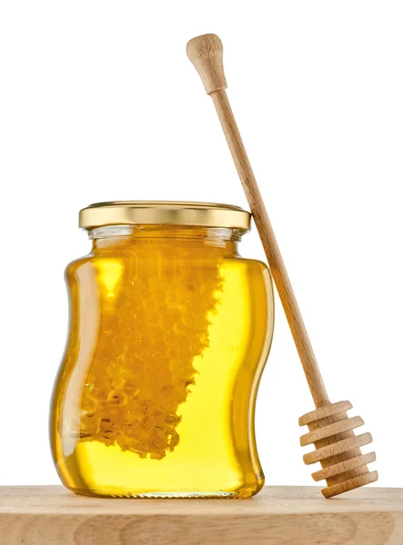 Vaso de miel con panal sobre blanco Fotos de stock