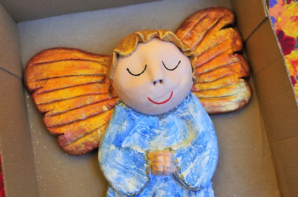 Little wooden painted angel figure sleeping in box — Stock Photo, Image