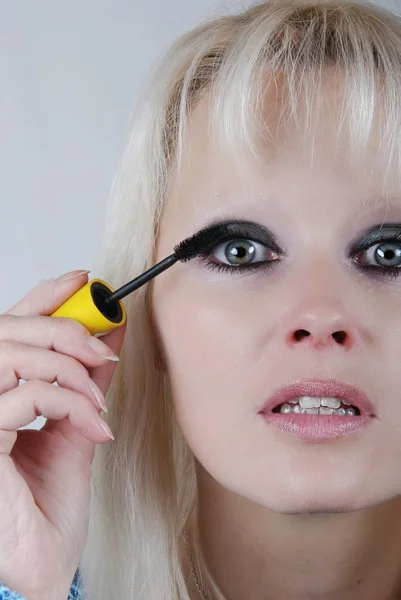 Vrouw aanbrengen van make-up op haar gezicht — Stockfoto