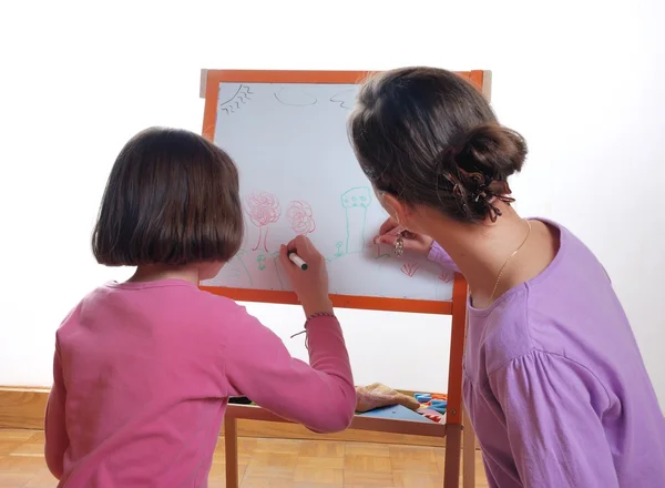 Youngs girls drawing on the white board — Stock Photo, Image