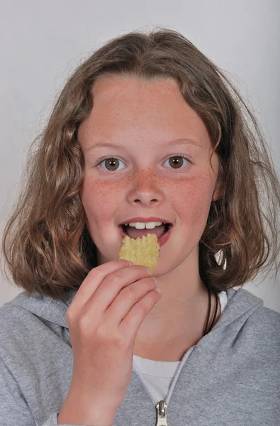 Girl eating chip — Stock Photo, Image