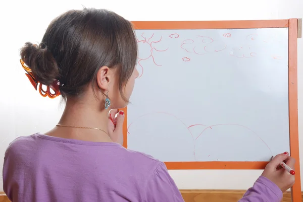 Young girl drawing on the white board — Stock Photo, Image