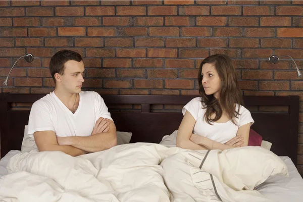 Upset young couple in the bed — Stock Photo, Image