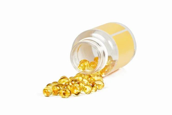 Yellow omega 3 capsules isolated on white Royalty Free Stock Images