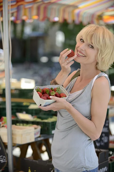 Mujer comprando fresas en el mercado de agricultores — Foto de Stock