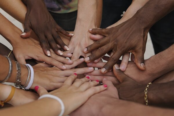 Many hands together: group of joining hands