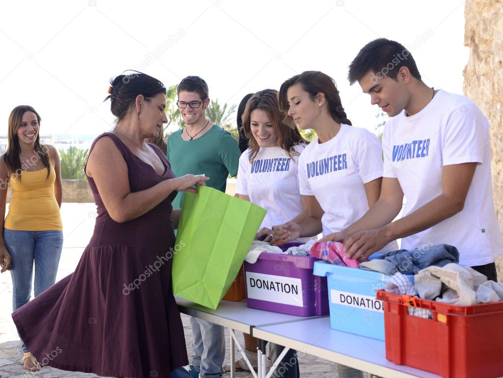 Group of volunteers collecting clothing donations — Stock Photo