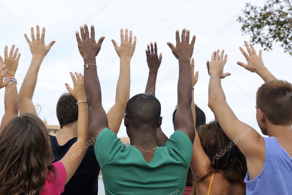 Diverse group raising hands