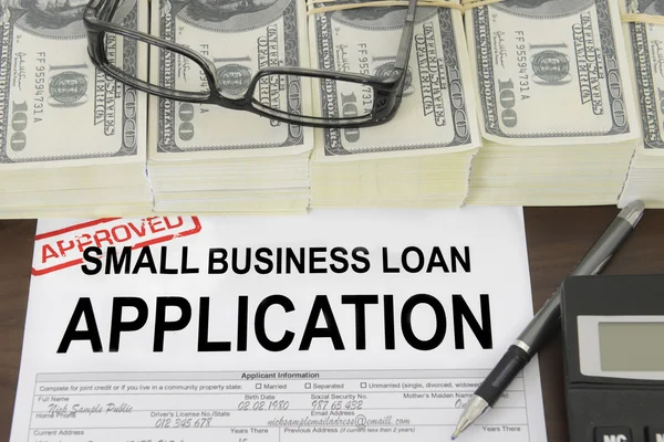 Approved small business loan application form and money — Stock Photo, Image