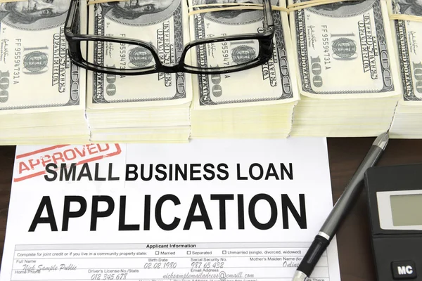 Approved small business loan application form and money — Stock Photo, Image