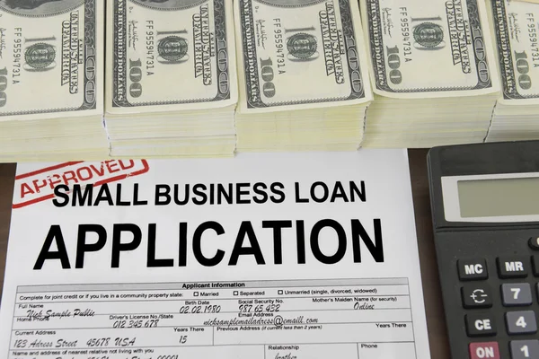 Approved small business loan application form and money — Stock Photo, Image