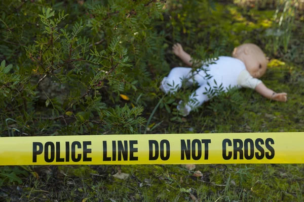 Crime scene in the forest with doll — Stock Photo, Image