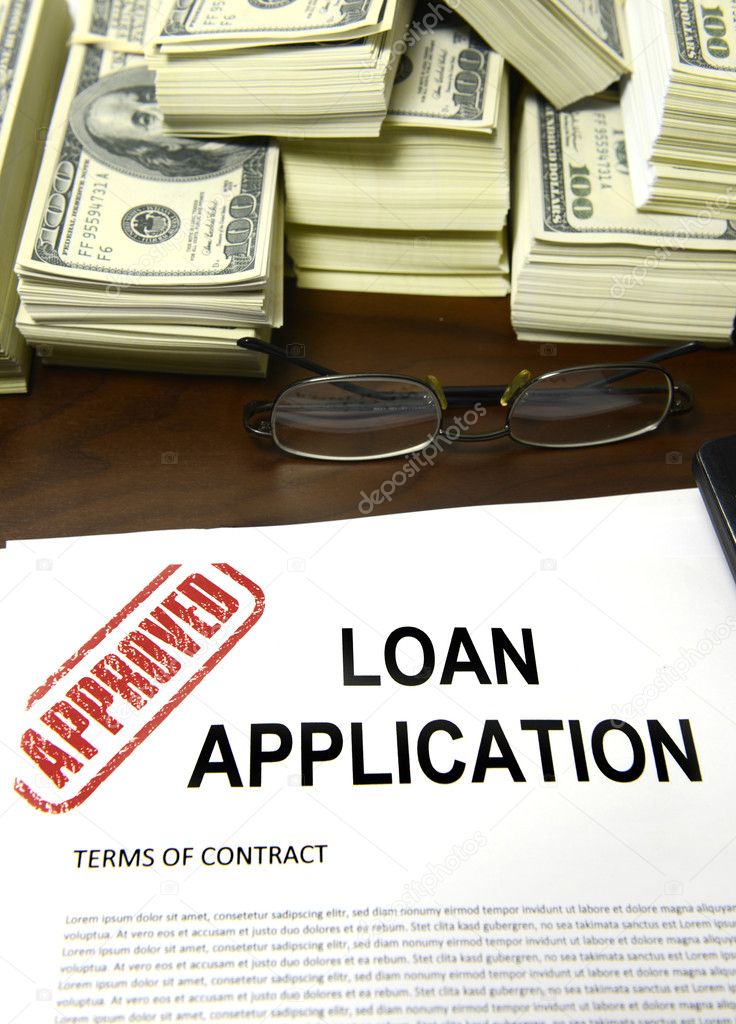 Approved loan application and dollar bills