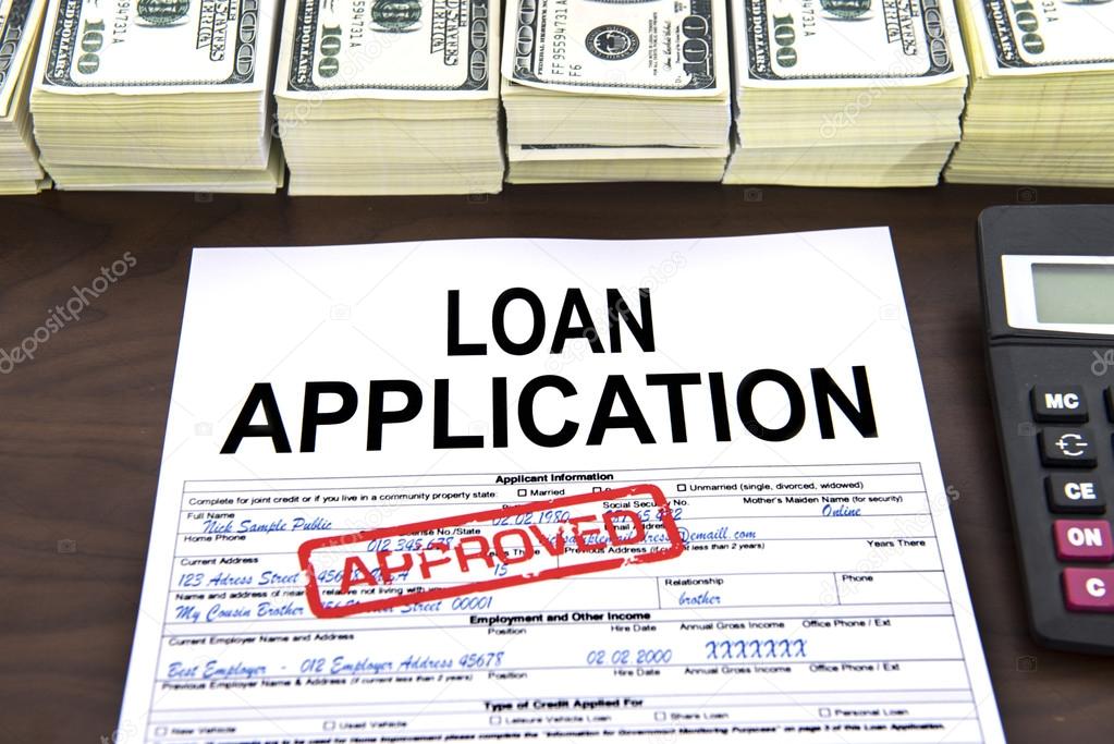 Approved loan application form and dollar bills