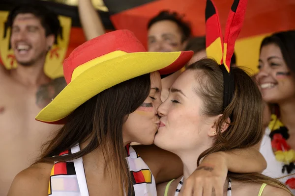 German lesbian soccer fans kissing each other — Stock Photo, Image
