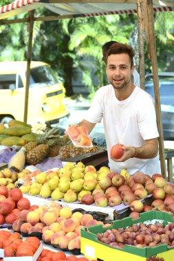 Small business owner selling organic fruits and vegetables clipart