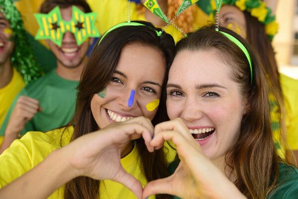 Cheerful girlfriends soccer fans