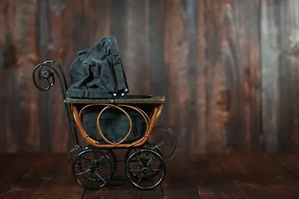 Baby Cradle on Grunge Wooden Background — Stock Photo, Image