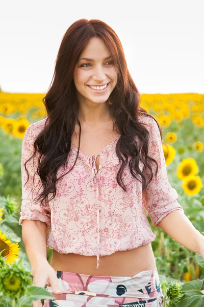 Beautiful lady walking in sunflower field — Stock Photo, Image