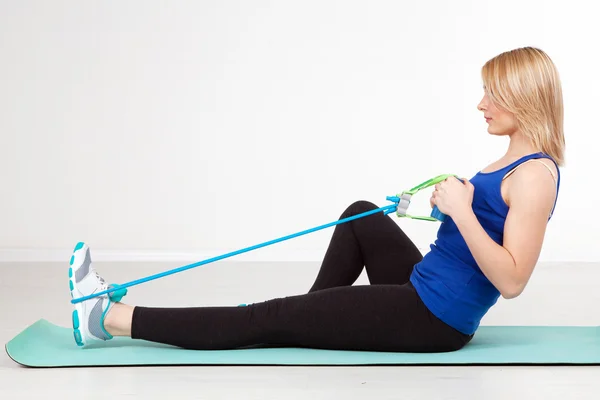 Woman exercising with a rubber band — Stock Photo, Image