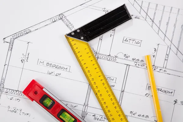 Construction tools on a blueprint — Stock Photo, Image