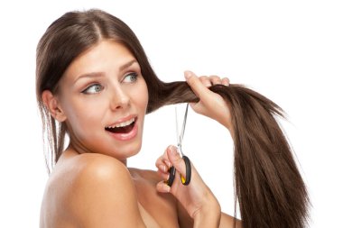 Beautiful young woman cutting her hair clipart