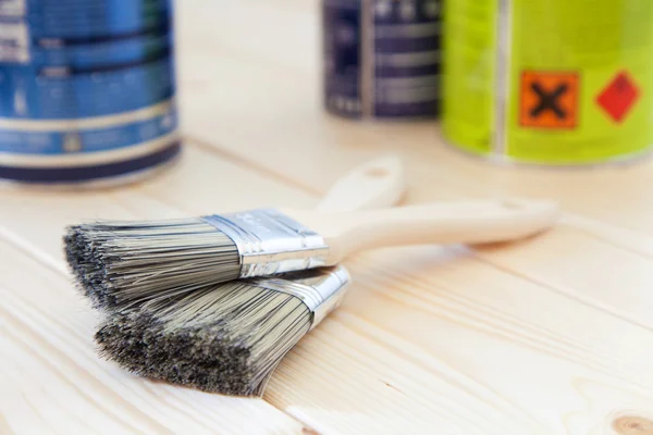 Paint brushes on wooden planks — Stock Photo, Image