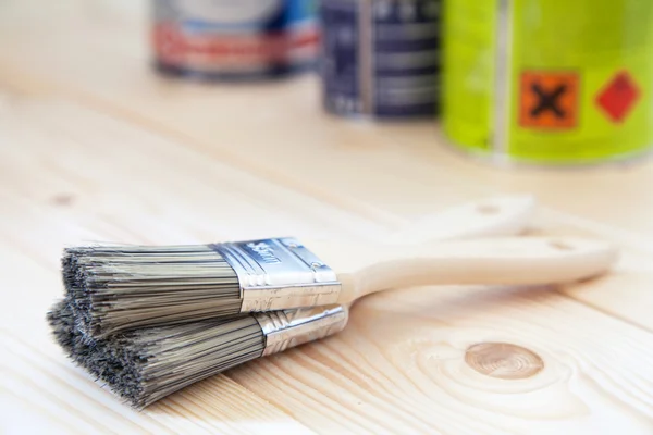 Paint brushes on wooden planks — Stock Photo, Image