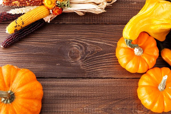 Fresh pumpkins on a wooden table — Stock Photo, Image