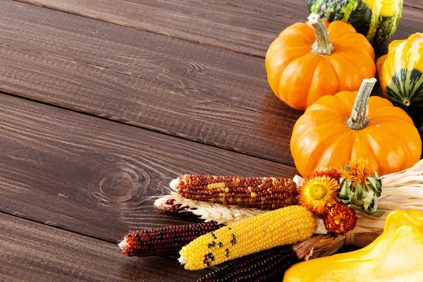 Fresh pumpkins on a wooden table — Stock Photo, Image