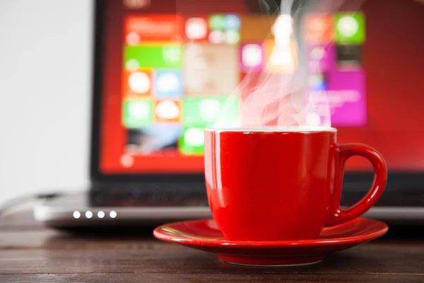 Laptop e uma xícara de café — Fotografia de Stock