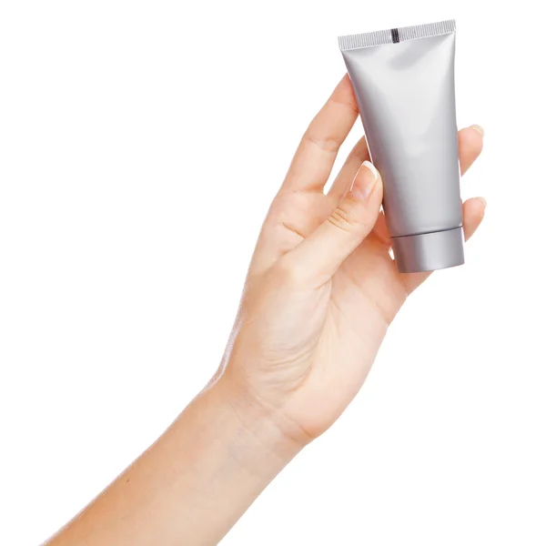 Female hand holding a cream tube — Stock Photo, Image